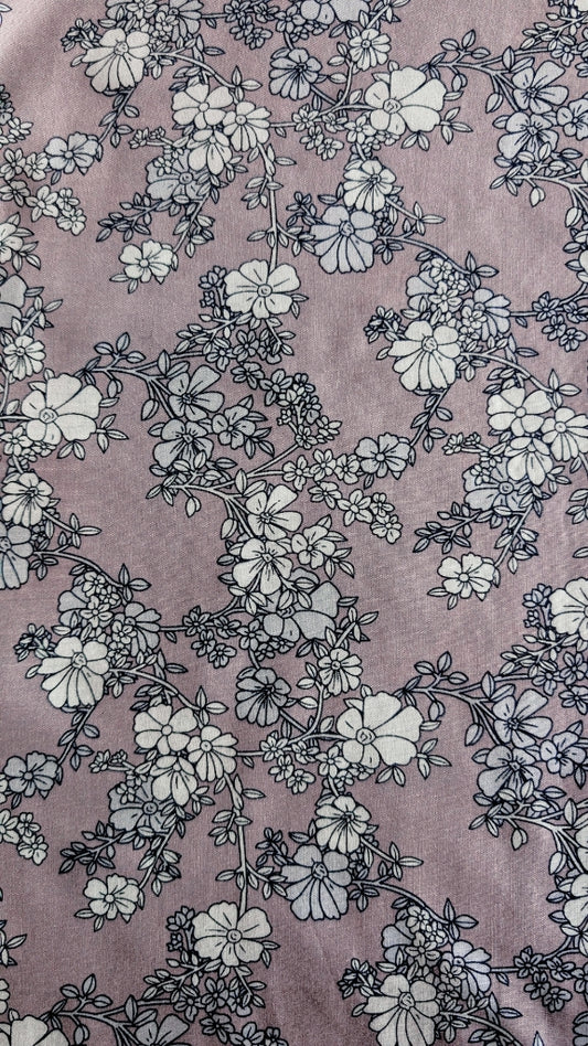 Floral pattern on a textured surface with a pinkish-purple background