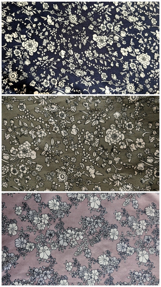Three floral fabric in navy Dusty green and mauve each featuring white botanical prints arranged vertically
