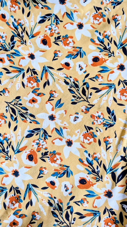 Yellow honey meadow floral print prayer abaya with matching hijab on plain studio background