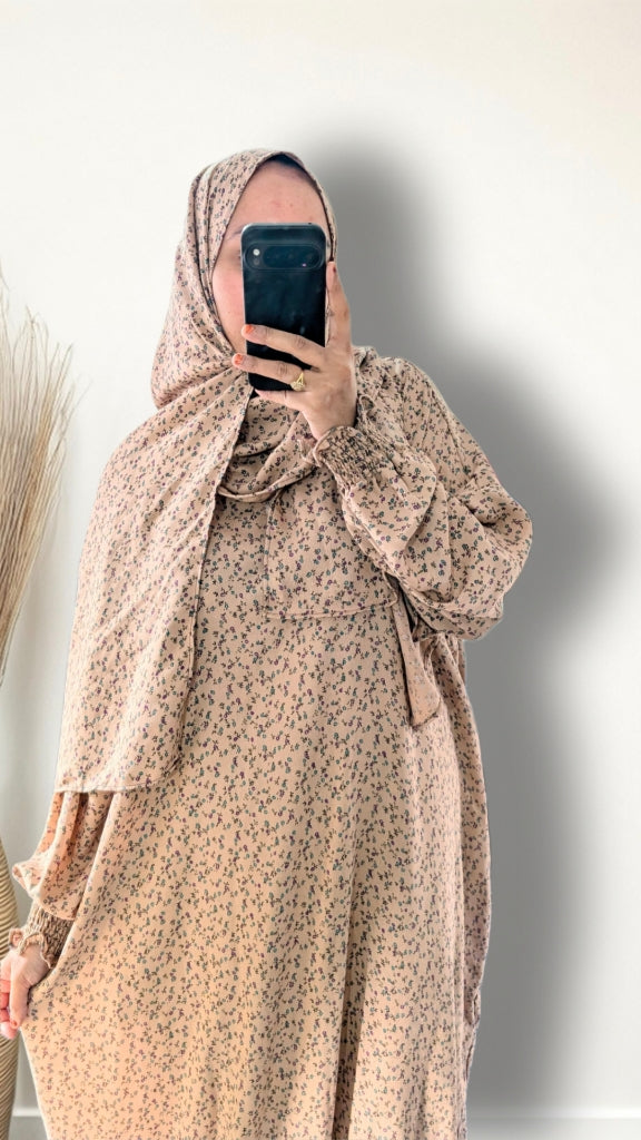 Warm beige ditsy floral print prayer abaya with matching hijab on plain studio background