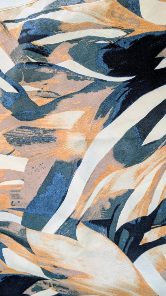 Abstract painterly pattern fabric with flowing brushstrokes in navy blue, slate blue, peach, cream, and white.
