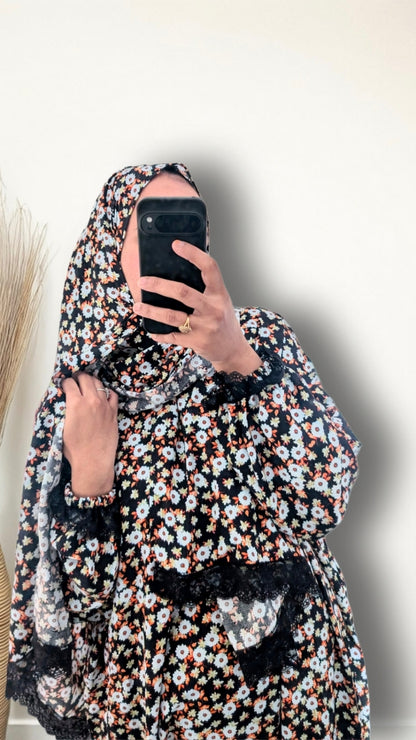 Muslim women wearing Black Daisy Floral print prayer abaya with matching hijab on plain studio background