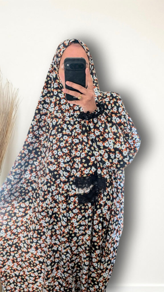 Muslim women wearing Black Daisy Floral print prayer abaya with matching hijab on plain studio background