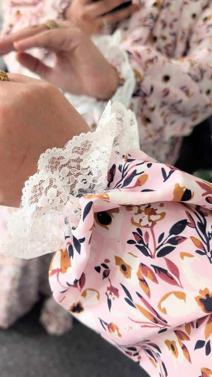 Close-up of a floral-patterned elastic cuff sleeve with lace trim