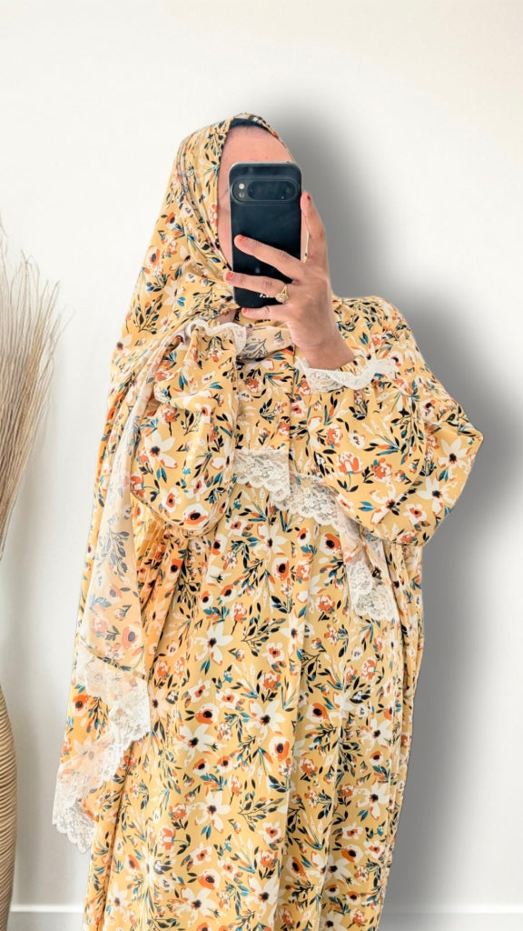 Yellow honey meadow floral print prayer abaya with matching hijab on plain studio background