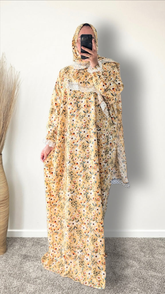 Yellow honey meadow floral print prayer abaya with matching hijab on plain studio background