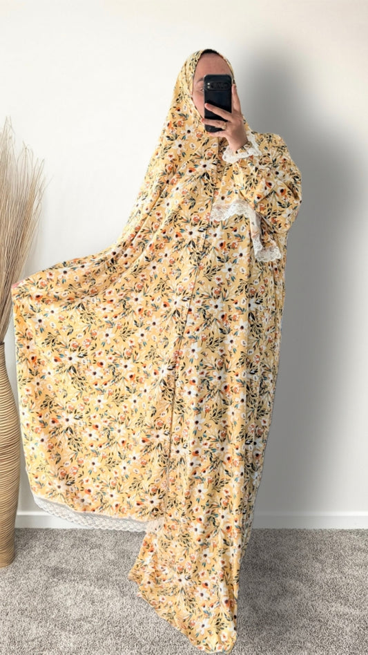 Yellow honey meadow floral print prayer abaya with matching hijab on plain studio background