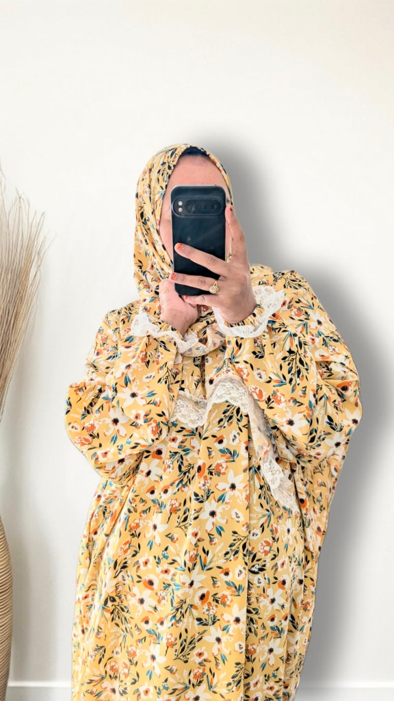 Yellow honey meadow floral print prayer abaya with matching hijab on plain studio background