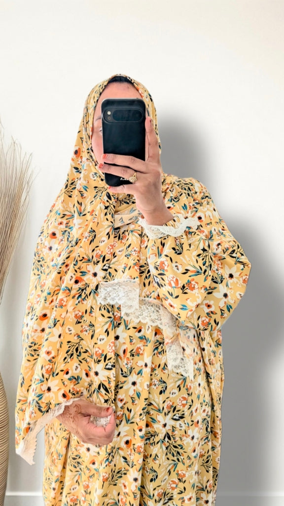 Yellow honey meadow floral print prayer abaya with matching hijab on plain studio background
