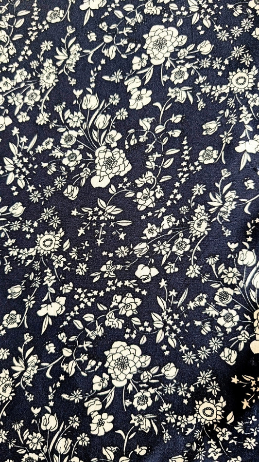 Navy blue fabric with small white floral pattern