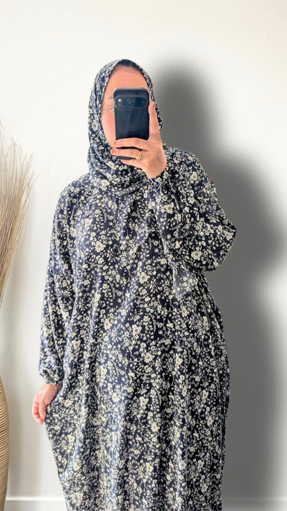 Navy floral botanical print prayer abaya with matching hijab on plain studio background