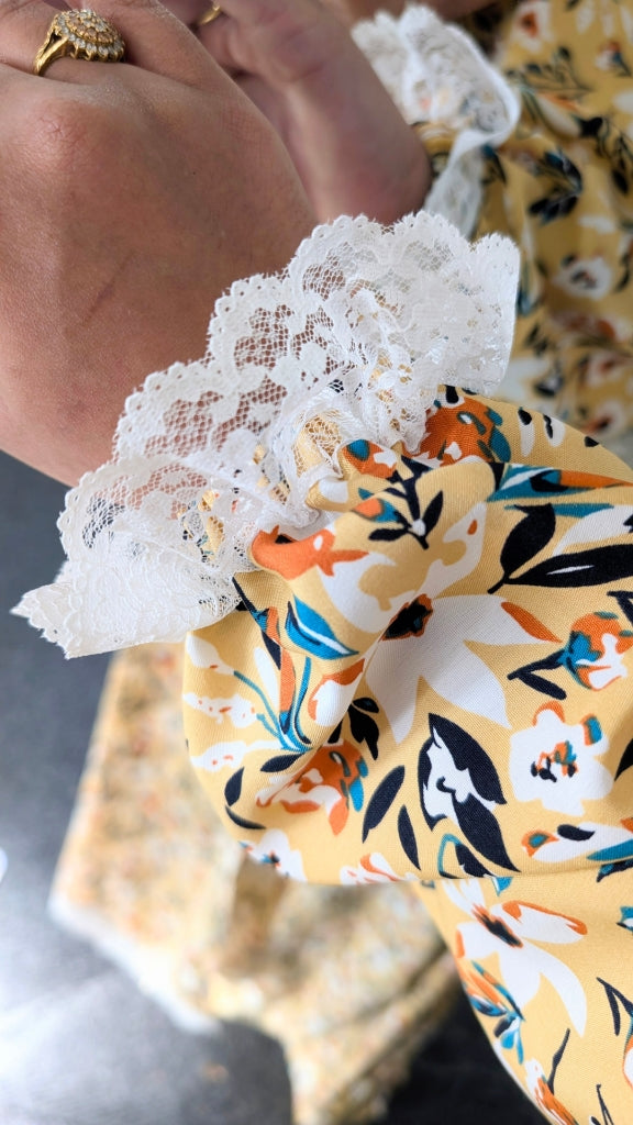 Yellow honey meadow floral print prayer abaya with matching hijab on plain studio background