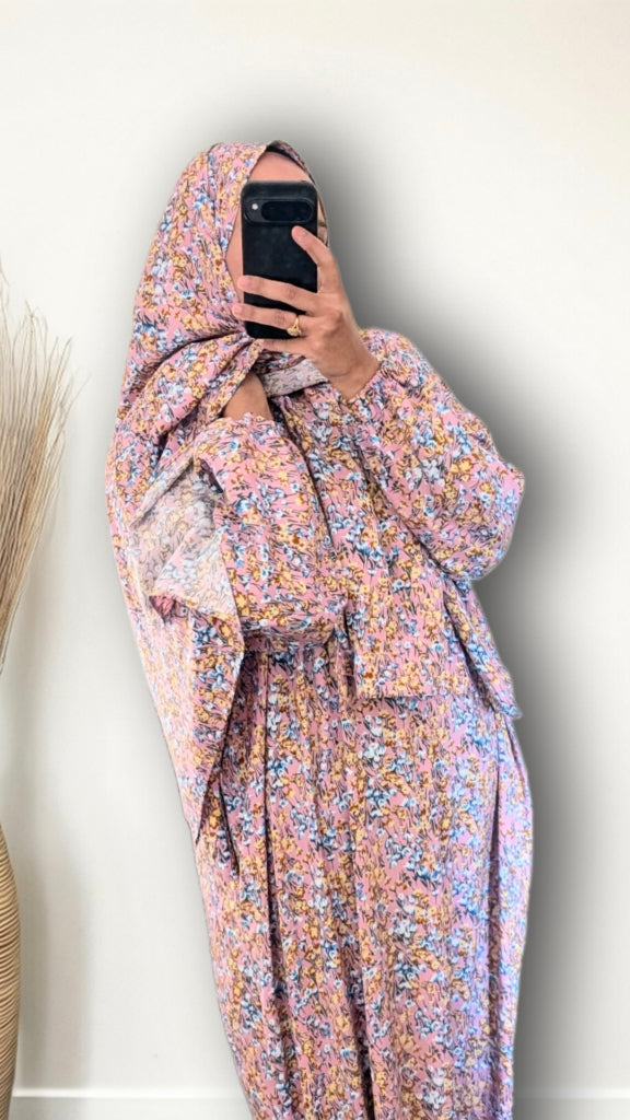 Muslim women wearing Rose Pink ditsy floral print prayer abaya with matching hijab on plain studio background