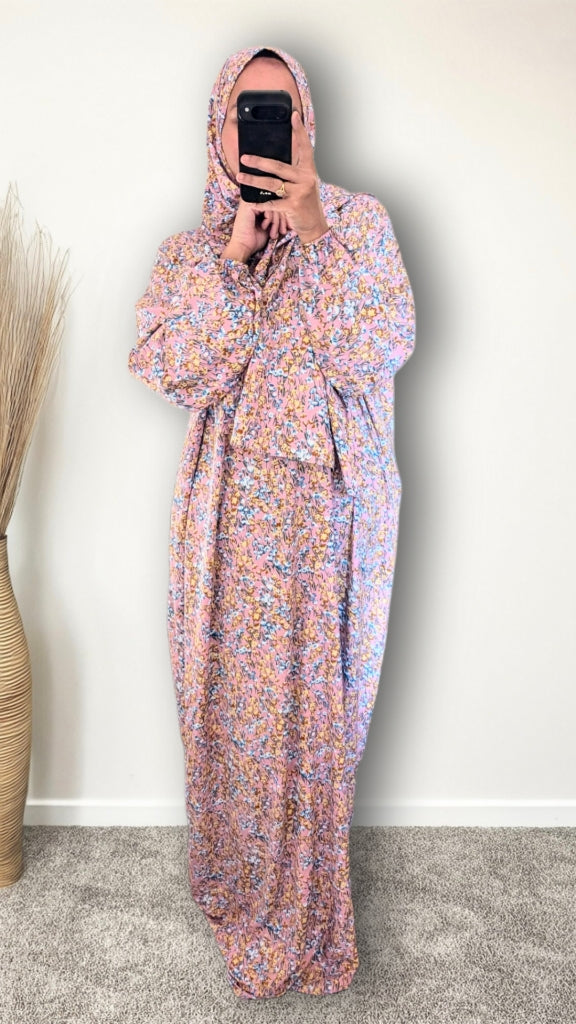 Muslim women wearing Rose Pink ditsy floral print prayer abaya with matching hijab on plain studio background