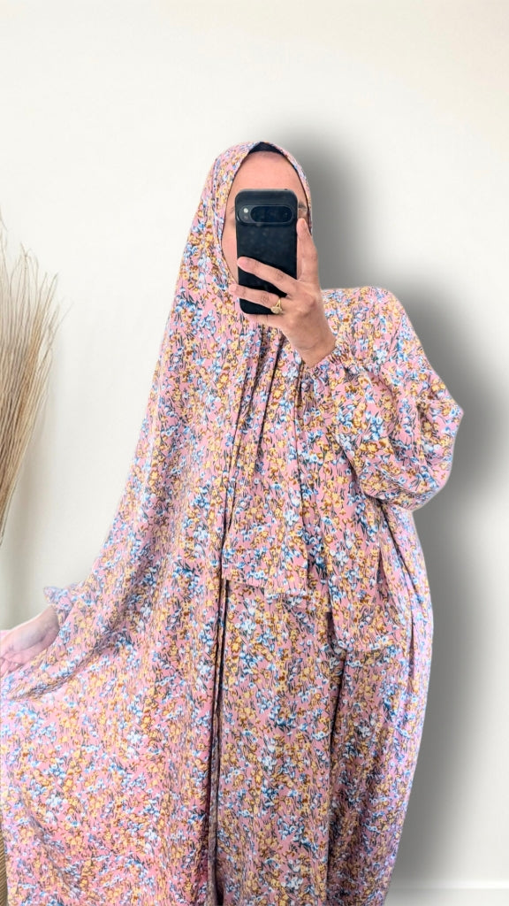 Muslim women wearing Rose Pink ditsy floral print prayer abaya with matching hijab on plain studio background