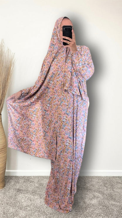 Muslim women wearing Rose Pink ditsy floral print prayer abaya with matching hijab on plain studio background