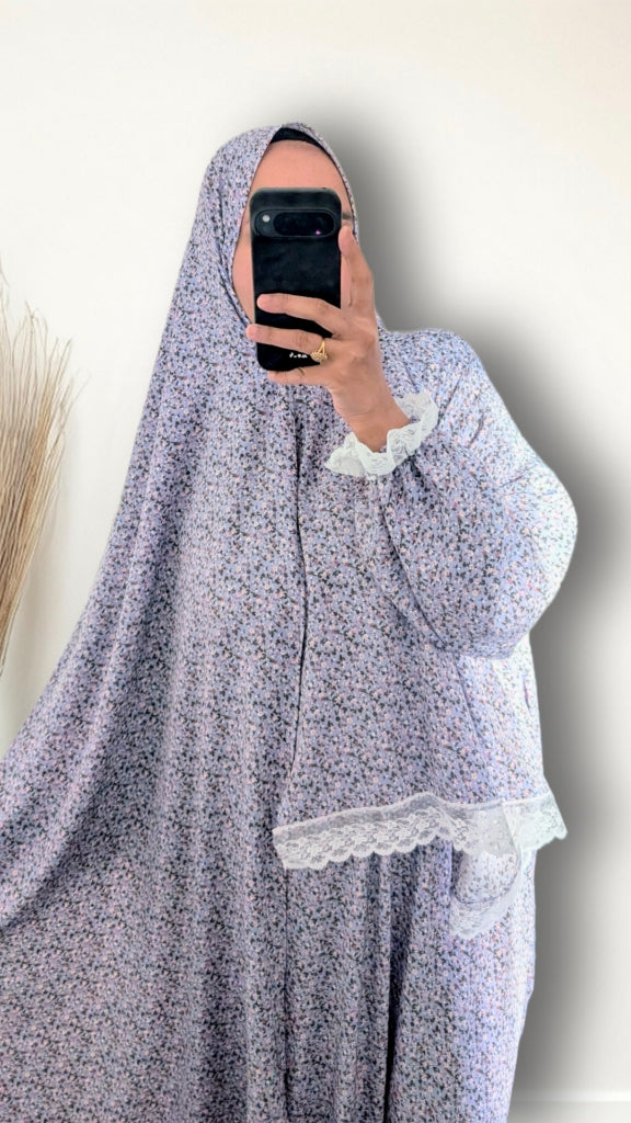 Muslim women wearing sky blue blossom floral  print prayer abaya with matching hijab on plain studio background