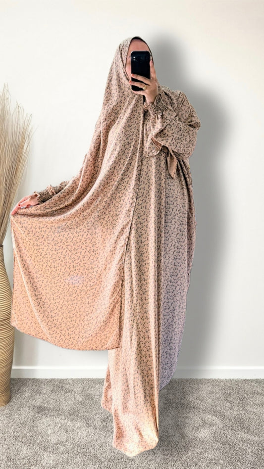 Warm beige ditsy floral print prayer abaya with matching hijab on plain studio background